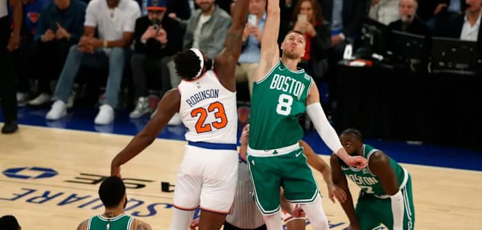 Kristaps Porzingis (8) makes Wednesday's opening tip-off against Mitchell Robinson
